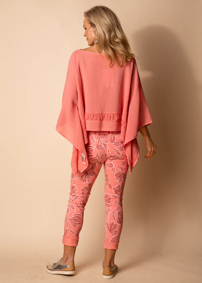 Embrace vibrant charm with our Coral Crush Cali Pants. The energetic coral shade, accentuated by the intricate white floral print, captures attention and exudes confidence. These full-length pants are not just a visual delight but also a comfort-focused choice, thanks to the stretchy fabric, drawstring waist, and elastic band.  Material - Naturally derived viscose.  Designed In Australia