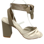 The soft leather and 9cm block heel make these little sandals a comfortable summer option. The twisted front and soft tie at the ankle are flattering features. Colours available are two-toned cream and dark taupe.  Made in Brazil.