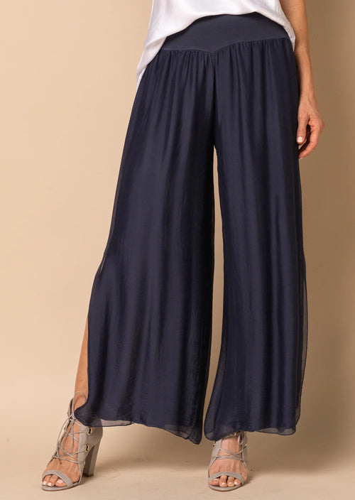 The Gia pant is a long romantic flowing pants with a mid-calve slit up the outer leg. It is made from delicate, silk. The wrap waistband is elasticized and stays flat to offer a lovely figure-flattering shape. You no longer do you need to sacrifice comfort for style!  Material - 100% Silk Outer  Designed In Australia