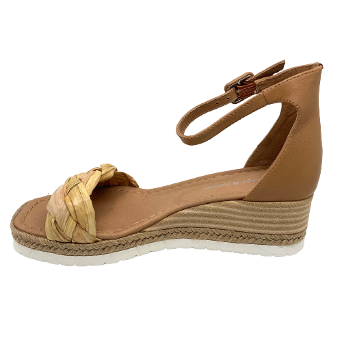 Here's a handy versatile little summer wedge. Easy to match tan leather is used in the heel cup and ankle strap and the front strap is a wide, chunky band of neutral colours of plaited raffia. A stacked leather wedge with a band of plaited hessian and white rubber sole finishes this sandal of beautifully.