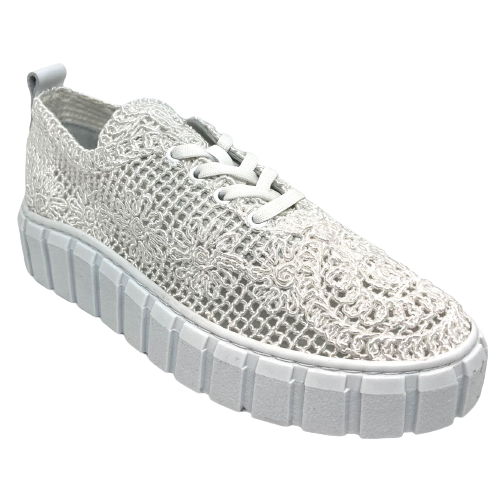 Made in Turkey by Rilasarre this comfortable little summer sneaker is mesh covered in a white lace. It has a cushioned footbed and a chunky white sole and is cool and ventilated for our summer months.