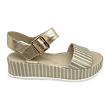Elevate you casual style! When you need to be dressed but still want the comfort a flat shoe gives then these metallic sandals are perfect. The striped gold leather of the soft wide strap across the toe is repeated in the platform and the Y back is in plain gold leather. Made by Django and Juliette.