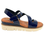 This is an extremely soft soled, comfortable and supportive sandal with a super spongy foot bed. The soft patent leather is available in both mustard and navy. The white sole offsets a patent leather covered wedge. Made in Spain.