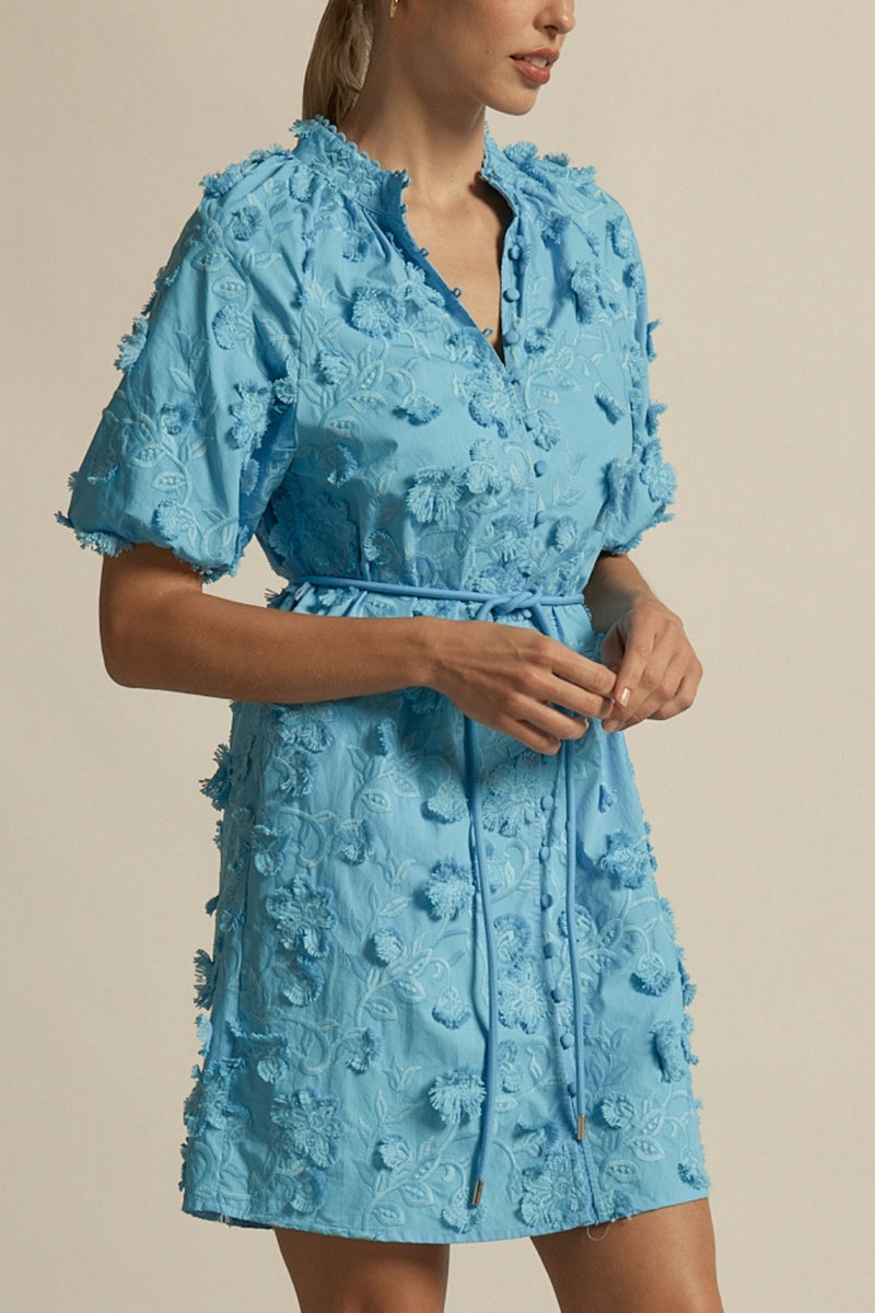 crafted in cotton, the aspect dress combines a dynamic 3D floral broderie with a scalloped lace neckline finish. A piece designed for elevated and romantic summer dressing.

100% cotton, trims: 100% polyester 
Covered buttons running from neckline to hem
Fabric covered belt with brass ends for versatile styling options 
Elbow length raglan sleeve 
3d floral broderie finish adds a sense of feminine charm 
Mini-length finishing mid-thigh