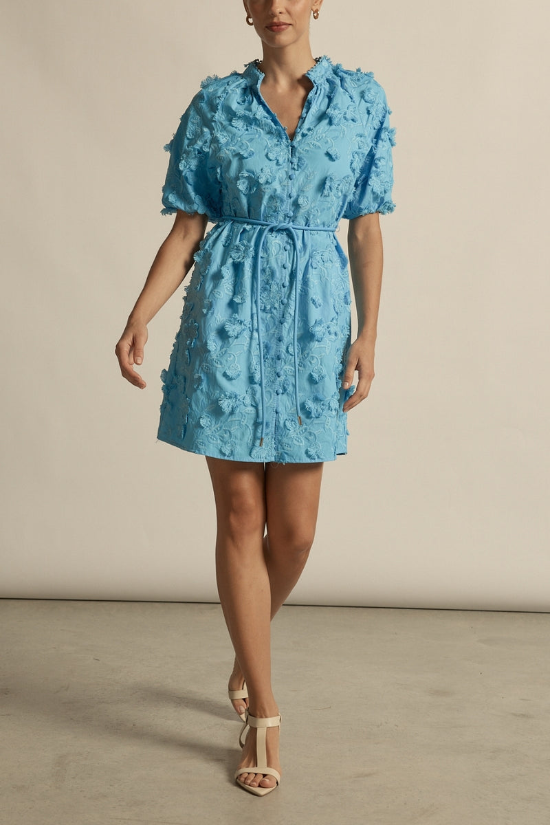crafted in cotton, the aspect dress combines a dynamic 3D floral broderie with a scalloped lace neckline finish. A piece designed for elevated and romantic summer dressing.

100% cotton, trims: 100% polyester 
Covered buttons running from neckline to hem
Fabric covered belt with brass ends for versatile styling options 
Elbow length raglan sleeve 
3d floral broderie finish adds a sense of feminine charm 
Mini-length finishing mid-thigh