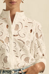 quietly elevated blouse, the Recollect top combines tailoring with soft details.&nbsp;

Lace accents and tulip sleeves lend charm to a clean-lined silhouette.

100% linen composition
circular lace detailing at the shoulder
v-neck split with covered dome button
short gathered tulip sleeve
neat, refined structure