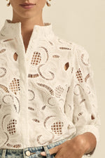 quietly elevated blouse, the Recollect top combines tailoring with soft details.&nbsp;

Lace accents and tulip sleeves lend charm to a clean-lined silhouette.

100% linen composition
circular lace detailing at the shoulder
v-neck split with covered dome button
short gathered tulip sleeve
neat, refined structure