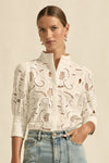 quietly elevated blouse, the Recollect top combines tailoring with soft details.&nbsp;

Lace accents and tulip sleeves lend charm to a clean-lined silhouette.

100% linen composition
circular lace detailing at the shoulder
v-neck split with covered dome button
short gathered tulip sleeve
neat, refined structure