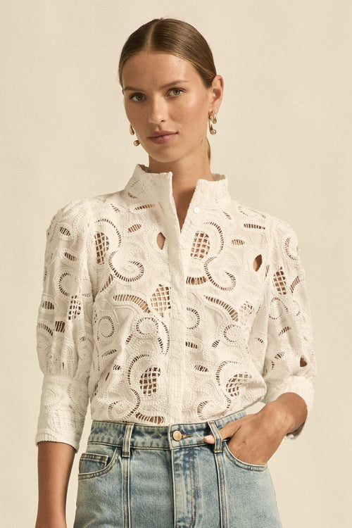 quietly elevated blouse, the Recollect top combines tailoring with soft details.&nbsp;

Lace accents and tulip sleeves lend charm to a clean-lined silhouette.

100% linen composition
circular lace detailing at the shoulder
v-neck split with covered dome button
short gathered tulip sleeve
neat, refined structure