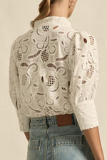 quietly elevated blouse, the Recollect top combines tailoring with soft details.&nbsp;

Lace accents and tulip sleeves lend charm to a clean-lined silhouette.

100% linen composition
circular lace detailing at the shoulder
v-neck split with covered dome button
short gathered tulip sleeve
neat, refined structure