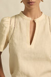 quietly elevated blouse, the Recollect top combines tailoring with soft details.&nbsp;

Lace accents and tulip sleeves lend charm to a clean-lined silhouette.

100% linen composition
circular lace detailing at the shoulder
v-neck split with covered dome button
short gathered tulip sleeve
neat, refined structure