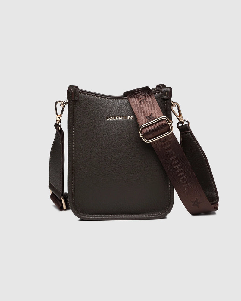 The Louenhide Parker Phone Crossbody Bag effortlessly combines an elevated aesthetic with everyday functionality. Whether you're heading to the office, running errands or meeting friends for coffee, this minimalistic phone bag will be your new go-to. Parker features an on-trend and modern silhouette, enhanced by the contrasting stitch details in three classic colour ways. Elevate your style with the sateen webbing guitar strap or keep it simple with the matching vegan leather crossbody strap. Keeping your e
