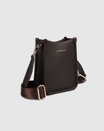 The Louenhide Parker Phone Crossbody Bag effortlessly combines an elevated aesthetic with everyday functionality. Whether you're heading to the office, running errands or meeting friends for coffee, this minimalistic phone bag will be your new go-to. Parker features an on-trend and modern silhouette, enhanced by the contrasting stitch details in three classic colour ways. Elevate your style with the sateen webbing guitar strap or keep it simple with the matching vegan leather crossbody strap. Keeping your e