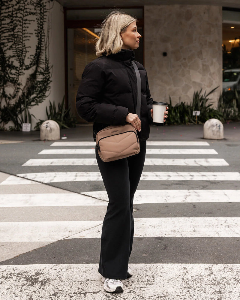 nternal Features	Zip Pocket, Slip Pocket
External Features	Front Side Zip Pocket, Back Side Zip Pocket
Internal Lining	Polyester Recycled Black and White Stripe Logo 100% Lining
Crossbody Strap	Adjustable and Detachable 80-145cm Sateen Strap
Closure	Secure Zip
Body Material	Satin Finish Polyurethane 100%
Hardware	Black
Dimensions	W23 x H19 x D9cm
Weight	0.55kg
