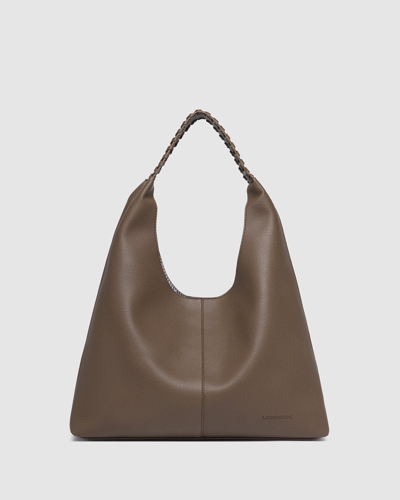 The Louenhide Avery Mocha Shoulder Bag is a modern take on the classic hobo bag with an elevated twist. The whipstitch detailing adds depth and texture to the shoulder bags exterior while the slouchy, minimalistic design adds a soft yet sleek element to your capsule wardrobe. The seamless teardrop silhouette sits comfortably over the shoulder, while offering ample interior space to fit your everyday essentials and more. With its timeless blend of structure and softness, elevate your everyday with the Avery 