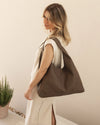 The Louenhide Avery Mocha Shoulder Bag is a modern take on the classic hobo bag with an elevated twist. The whipstitch detailing adds depth and texture to the shoulder bags exterior while the slouchy, minimalistic design adds a soft yet sleek element to your capsule wardrobe. The seamless teardrop silhouette sits comfortably over the shoulder, while offering ample interior space to fit your everyday essentials and more. With its timeless blend of structure and softness, elevate your everyday with the Avery 