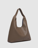 The Louenhide Avery Mocha Shoulder Bag is a modern take on the classic hobo bag with an elevated twist. The whipstitch detailing adds depth and texture to the shoulder bags exterior while the slouchy, minimalistic design adds a soft yet sleek element to your capsule wardrobe. The seamless teardrop silhouette sits comfortably over the shoulder, while offering ample interior space to fit your everyday essentials and more. With its timeless blend of structure and softness, elevate your everyday with the Avery 
