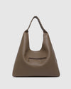 The Louenhide Avery Mocha Shoulder Bag is a modern take on the classic hobo bag with an elevated twist. The whipstitch detailing adds depth and texture to the shoulder bags exterior while the slouchy, minimalistic design adds a soft yet sleek element to your capsule wardrobe. The seamless teardrop silhouette sits comfortably over the shoulder, while offering ample interior space to fit your everyday essentials and more. With its timeless blend of structure and softness, elevate your everyday with the Avery 