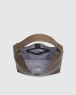 The Louenhide Avery Mocha Shoulder Bag is a modern take on the classic hobo bag with an elevated twist. The whipstitch detailing adds depth and texture to the shoulder bags exterior while the slouchy, minimalistic design adds a soft yet sleek element to your capsule wardrobe. The seamless teardrop silhouette sits comfortably over the shoulder, while offering ample interior space to fit your everyday essentials and more. With its timeless blend of structure and softness, elevate your everyday with the Avery 