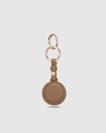 The Opal Mocha AirTag Case is a refined travel essential designed to bring both elegance and ease to your journey. Designed in a smooth vegan leather, Opal Mocha securely holds your Apple AirTag with a sleek press-stud closure, keeping your valuables traceable without compromising on style. Whether clipped to your handbag, keyring, or slipped inside your suitcase, Opal Mocha’s compact silhouette and easy-clip ring make her a subtle yet sophisticated addition to your travel routine. Lightweight, minimal, and
