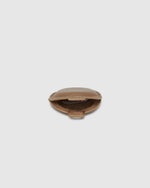 The Opal Mocha AirTag Case is a refined travel essential designed to bring both elegance and ease to your journey. Designed in a smooth vegan leather, Opal Mocha securely holds your Apple AirTag with a sleek press-stud closure, keeping your valuables traceable without compromising on style. Whether clipped to your handbag, keyring, or slipped inside your suitcase, Opal Mocha’s compact silhouette and easy-clip ring make her a subtle yet sophisticated addition to your travel routine. Lightweight, minimal, and