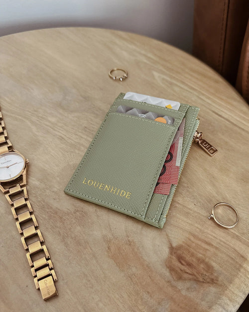 The Louenhide Cara Cardholder is a sleek and functional accessory, designed for everyday use. This cute card wallet features a central zip coin pocket, two note pockets and six cardholder spots. Find the perfect colour for you, choosing between a classic neutral, metallic or summer brights. Easily fit this cardholder style in your favourite Louenhide crossbody bag or if carry in your back pocket if you're a minimalist on the go!