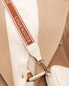 Internal Features	Zip Pocket, Slip Pocket
Internal Lining	Polyester Recycled Beige and White Stripe Logo 100% Lining
Crossbody Strap	Adjustable and Detachable 69-133cm Logo Webbing Strap
PU Strap	Adjustable and Detachable 110-124cm Vegan Leather Strap
Closure	Secure Zip
Body Material	Polyurethane Vegan Leather 100%
Hardware	Light Gold
Dimensions	W23 x H13 x D5cm
Weight	0.8kg