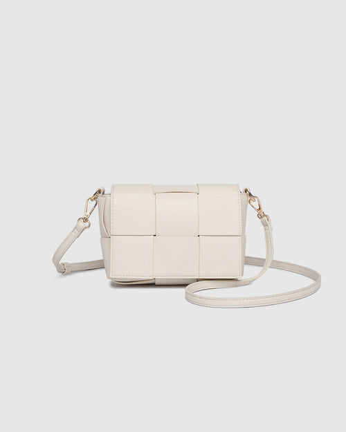 The Josephine Vanilla Crossbody Bag is a statement in both texture and versatility, designed to deliver effortless elegance from day to night. Crafted from woven vegan leather panels, she offers a modern twist on classic texture, adding a refined edge to everyday styling. This women’s woven handbag features a structured silhouette with a magnetic closure to keep your essentials secure, while light gold hardware lends a polished finish. With two interchangeable straps: a sleek vegan leather crossbody and a g