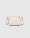 The Josephine Vanilla Crossbody Bag is a statement in both texture and versatility, designed to deliver effortless elegance from day to night. Crafted from woven vegan leather panels, she offers a modern twist on classic texture, adding a refined edge to everyday styling. This women’s woven handbag features a structured silhouette with a magnetic closure to keep your essentials secure, while light gold hardware lends a polished finish. With two interchangeable straps: a sleek vegan leather crossbody and a g