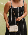 The Josephine Vanilla Crossbody Bag is a statement in both texture and versatility, designed to deliver effortless elegance from day to night. Crafted from woven vegan leather panels, she offers a modern twist on classic texture, adding a refined edge to everyday styling. This women’s woven handbag features a structured silhouette with a magnetic closure to keep your essentials secure, while light gold hardware lends a polished finish. With two interchangeable straps: a sleek vegan leather crossbody and a g