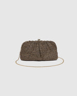 he Goldie Raffia Vanilla Clutch is your statement plus-one for any occasion, designed to elevate your look from daytime celebrations to evening soirées. This evening clutch features a slouchy yet structured silhouette, crafted in a raffia-like texture for a modern take on timeless texture. As a true gold chain clutch, Goldie Raffia Vanilla is finished with both a short and long gold chain strap, giving you the freedom to wear her in hand, over the shoulder, or crossbody. A polished kiss clip closure keeps y