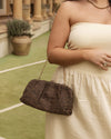 he Goldie Raffia Vanilla Clutch is your statement plus-one for any occasion, designed to elevate your look from daytime celebrations to evening soirées. This evening clutch features a slouchy yet structured silhouette, crafted in a raffia-like texture for a modern take on timeless texture. As a true gold chain clutch, Goldie Raffia Vanilla is finished with both a short and long gold chain strap, giving you the freedom to wear her in hand, over the shoulder, or crossbody. A polished kiss clip closure keeps y