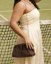 he Goldie Raffia Vanilla Clutch is your statement plus-one for any occasion, designed to elevate your look from daytime celebrations to evening soirées. This evening clutch features a slouchy yet structured silhouette, crafted in a raffia-like texture for a modern take on timeless texture. As a true gold chain clutch, Goldie Raffia Vanilla is finished with both a short and long gold chain strap, giving you the freedom to wear her in hand, over the shoulder, or crossbody. A polished kiss clip closure keeps y