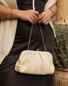 he Goldie Raffia Vanilla Clutch is your statement plus-one for any occasion, designed to elevate your look from daytime celebrations to evening soirées. This evening clutch features a slouchy yet structured silhouette, crafted in a raffia-like texture for a modern take on timeless texture. As a true gold chain clutch, Goldie Raffia Vanilla is finished with both a short and long gold chain strap, giving you the freedom to wear her in hand, over the shoulder, or crossbody. A polished kiss clip closure keeps y