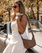 Internal Features	2 Slip Pockets
Internal Lining	Polyester Recycled Black and White Stripe 100% Lining
Crossbody Strap	Adjustable and Non-Detachable 34-65cm Vegan Leather Strap
Closure	Secure Zip
Body Material	Polyurethane Vegan Leather 100%
Hardware	Light Gold
Dimensions	W29 x H15.5 x D10cm
Weight	0.3kg