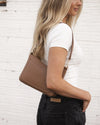 The Louenhide Linda Caramel Crossbody Bag is the new everyday staple. A classic silhouette meets modern design, this small crossbody bag is a little dressier than your typical everyday style. Wear her crossbody by day or change the straps to use as a shoulder bag by night. Stylish, practical and spacious enough to fit your essentials and more, this multiwear bag is as practical as she is versatile. Elevate your everyday with the Linda Caramel Crossbody Bag by your side.