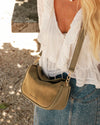 The Louenhide Saylor Sage Green Crossbody Bag brings a bold yet refined edge to your everyday styling. With its soft faux suede finish and sleek baguette-shaped silhouette, this cross body bag with chain detailing blends texture and refinement in all the right ways. Designed to be worn with ease but styled to stand out, the Saylor Sage Green moves effortlessly from day to night, adding impact to your layered winter looks. Wherever the day leads, this chain strap handbag is the finishing touch that completes
