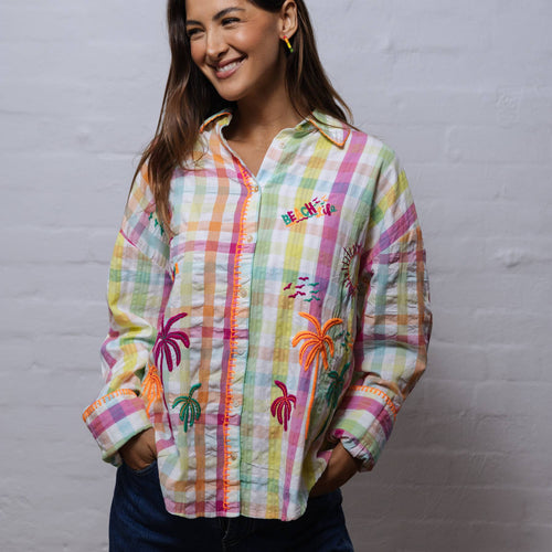 A loud and vibrant 100% cotton shirt which features blanket stitching and fluoro embroidery of palm tree and summery motifs.