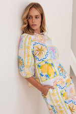 Matching shorts for your summer tops! 100% linen in the fresh Amalfi Dreams print in colours of lemon and blue, these mid length shorts have large front pockets, zip and button front, a flat band at the front and elastic at the back waist.