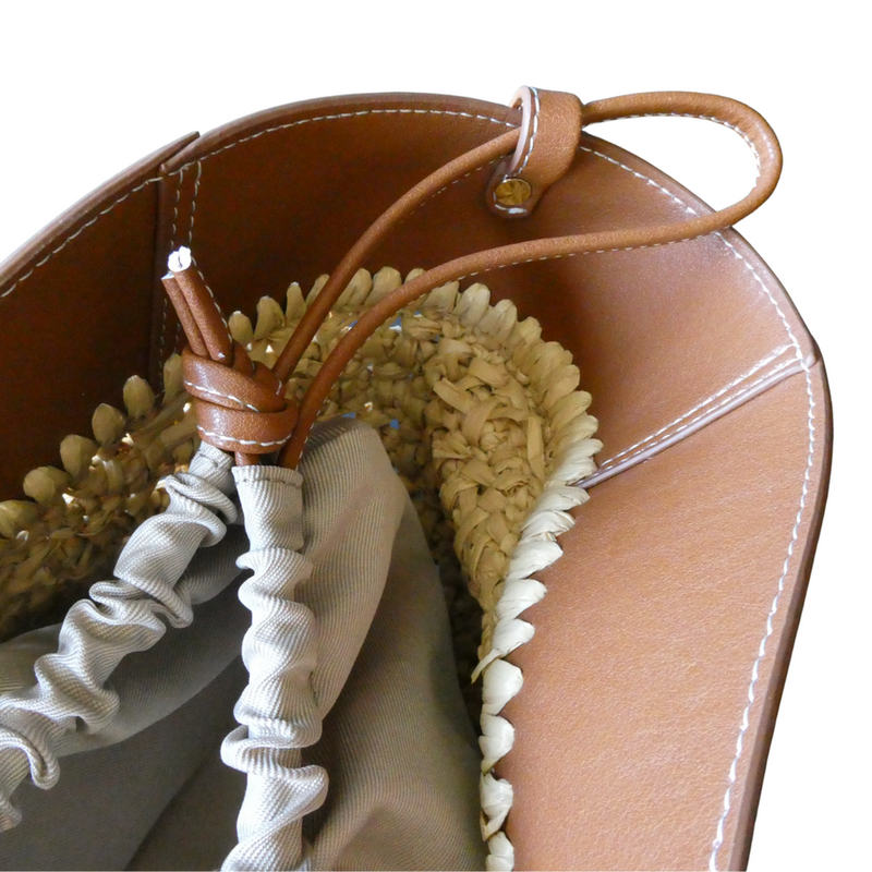 This gorgeous raffia and tan leather bag certainly makes a statement! A practical everyday bag with wow! It has two double straps so can be used as a grab bag or shoulder bag. A drawstring inner, as well as a magnetic clip, means all your goodies are kept safe and sound. Measures 53cm x 23cm