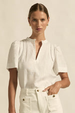 lace accents and tulip sleeves lend charm to a clean-lined silhouette.

100% linen composition
circular lace detailing at the shoulder
v-neck split with covered dome button
short gathered tulip sleeve
neat, refined structure