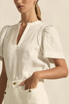 lace accents and tulip sleeves lend charm to a clean-lined silhouette.

100% linen composition
circular lace detailing at the shoulder
v-neck split with covered dome button
short gathered tulip sleeve
neat, refined structure