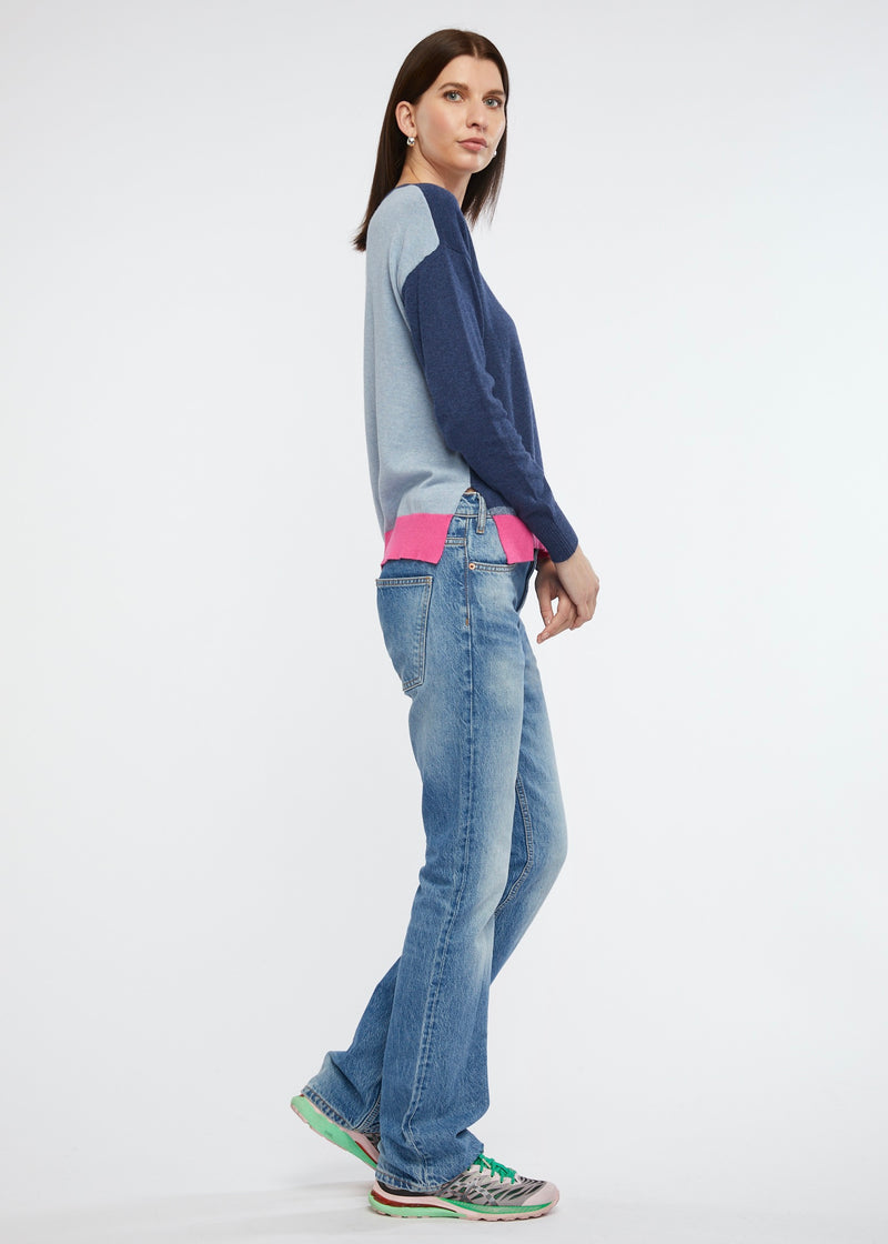 A light weight little jumper in cotton and cashmere from Zaket & Plover. Front and sleeves are a dark denim colour with the back being a lighter washed colour and trims of fuchsia pink.