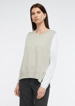 A simple round necked vest with side splits and knitted from a cotton and cashmere blend. Colour is marl.