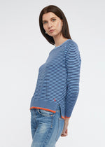 A must have in any wardrobe. Great to throw on with jeans for casual styling.  The chambray stripe is accentuated by vibrant orange in this knit of cotton and cashmere.