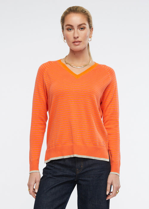 This light weight V necked jumper is perfect for your casual winter wardrobe. The stripe of vibrant fuchsia and orange is complimented by trims in a light grey. Knitted from cotton and cashmere by Zaket &amp; Plover.