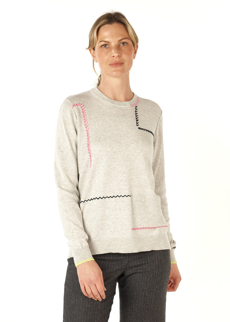 A beautifully soft knit of 5% cashmere and 95% cotton, this crew necked jumper has cross stitch and saddle stitching in black and pink wool features as well as a row of lime knitted into the bottom of each sleeve.