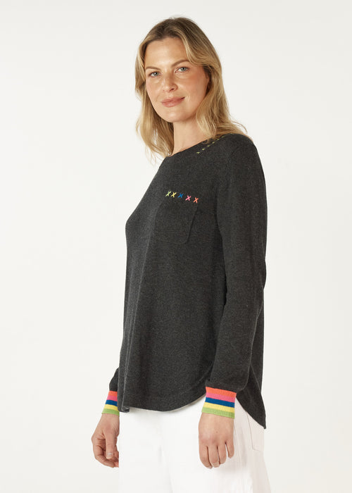 Designed to flatter, this A-line jumper features a cute breast pocket with X's handwork for a unique touch. Colourful striped cuffs add a fun pop of contrast, while the double-end hem creates a stylish, rounded shirt-like finish. 