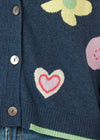 Add some fun and cuteness your winter wardrobed with our Happy Cardi. Knitted from 5% cashmere and 95% cotton yarn it features colourful heart and flower motifs, saddle stitching in wool on a mostly navy denim coloured background with lime cuffs and back.