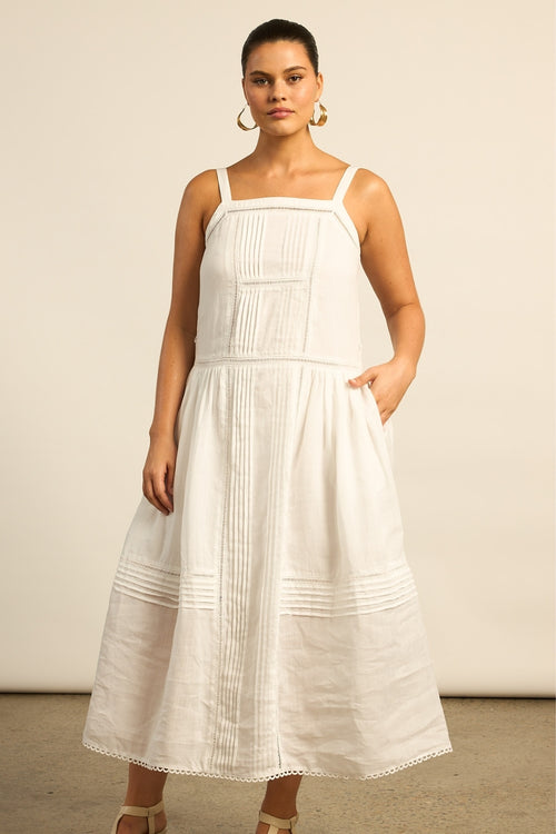 Cut in ramie with a colour-matched lining, the Altitude dress offers a relaxed and effortless aesthetic. A squared neckline is framed with delicate ladder lace, while the gathered skirt adds movement. Porcelain lends timeless ease to this flattering silhouette.

100% ramie with colour-matched lining
squared neckline with ladder-lace detail
gathered skirt for movement with scalloped lace hem finish